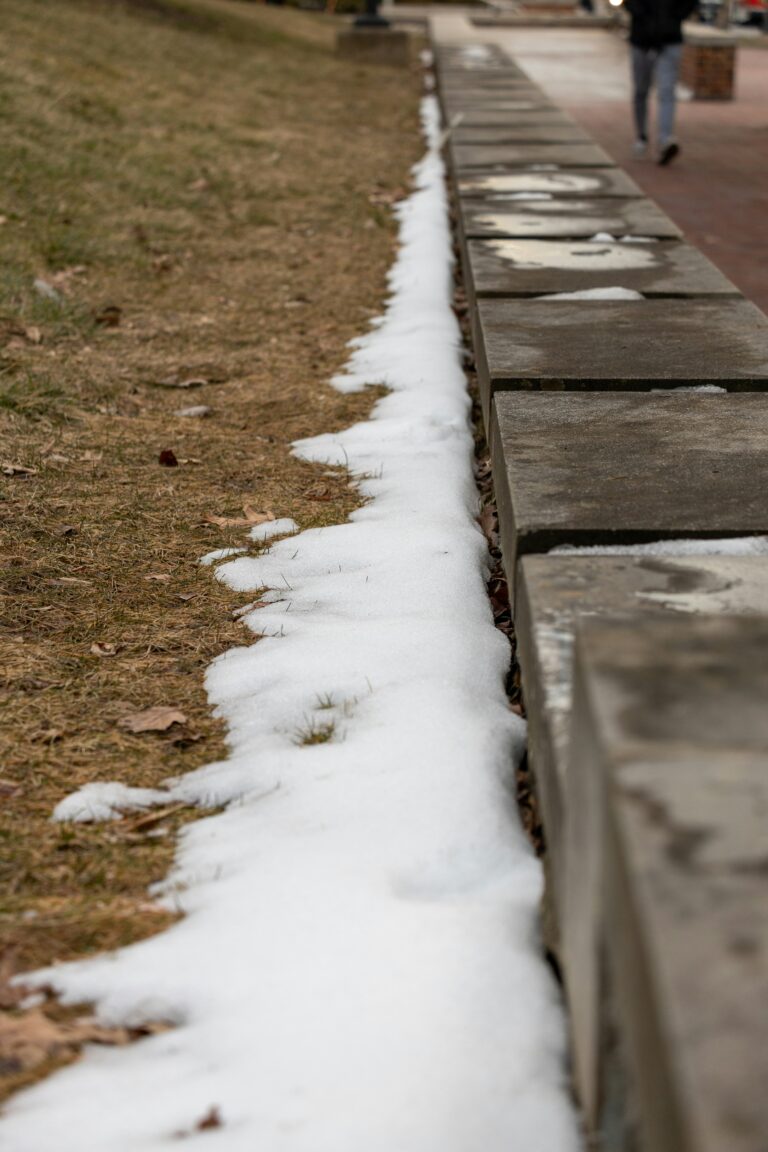 snow melting on snow and sidewalk